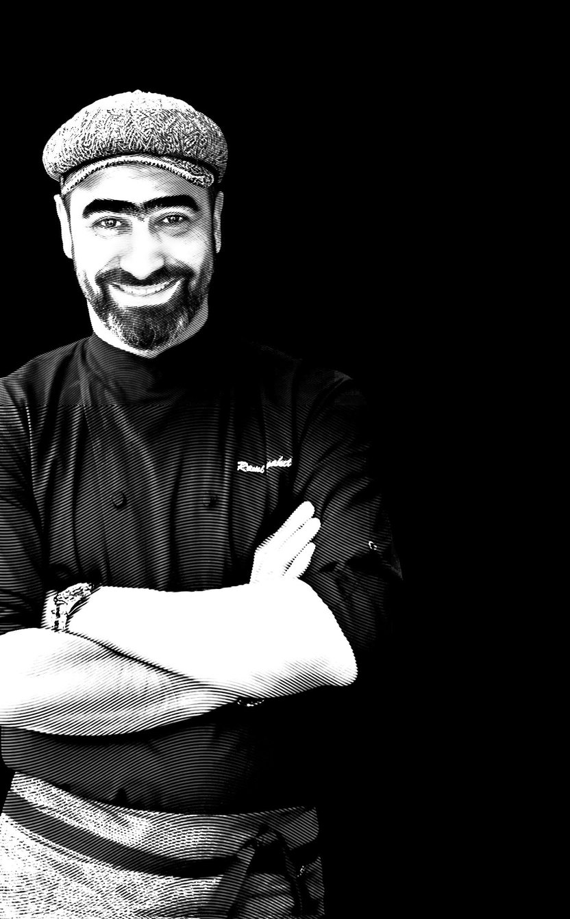 Engraved portrait of Chef Rami Al Maket, smiling in his cap and chef’s jacket with his arms folded